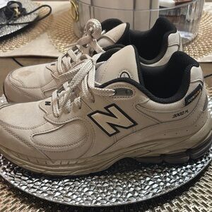 New Balance Beige and Black Sneakers